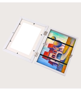 Detail of white dual folding picture frame with metal hinges and landscape oil painting