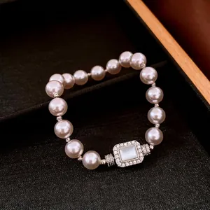 Luxury pearl bracelet with a rectangular crystal buckle and mother-of-pearl center