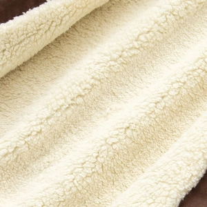 Detail shot of soft beige and brown faux shearling fleece texture on thick winter hoodie