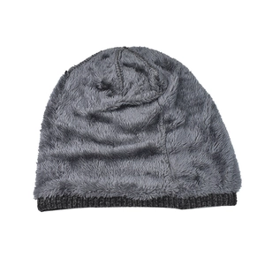 Detailed view of the thick gray knitted winter hat featuring soft fleece lining and ribbed edge