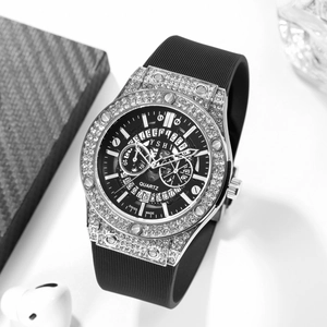 Detail of silver rhinestone watch case and black rubber strap with a quartz dial