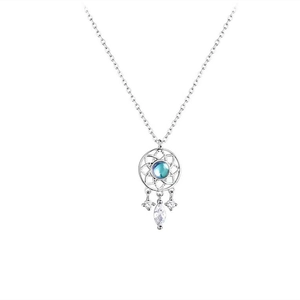 Macro shot of silver dreamcatcher necklace pendant with blue gemstone and white zirconias