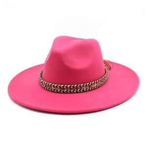 Detail of magenta fedora hat featuring an ethnic woven band and wide flat brim