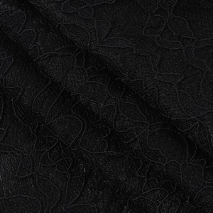 Close-up of elegant black lace fabric texture and floral crochet pattern details