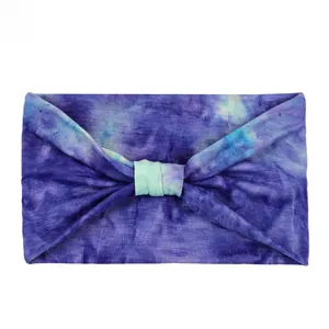 Detail of purple and blue tie-dye sports headband with decorative knot and soft texture