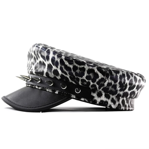 Close-up of leopard print flat top hat featuring metal rivets and black leather brim
