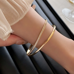 Detailed view of double-layer gold plated bracelet with sparkling zircon stones on wrist