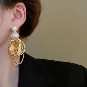 Elegant gold irregular circle drop earrings with large pearls for a modern luxury look