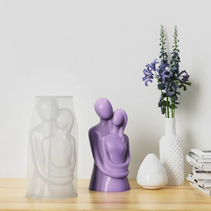 Macro view of silicone mold and finished couple embrace candle art on wooden table