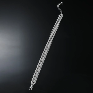 Detail of silver Cuban link anklet featuring densely set sparkling rhinestones with lobster clasp
