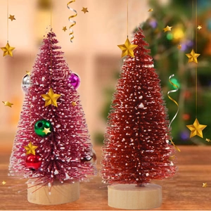 Close-up of mini flocked Christmas trees with snow effect and wooden base ornaments