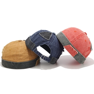 Vintage docker hats in washed canvas featuring distressed patch details and frayed edges