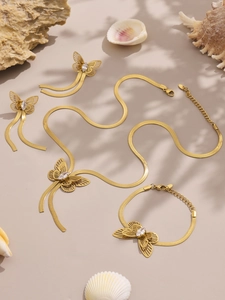 Detail of gold double butterfly jewelry set with 5A zircon on aesthetic shell background