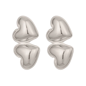 Close-up of double-layered heart-shaped silver earrings with 3D polished finish