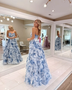 Detail view of the tiered blue floral gown featuring a corset bodice and elegant strapless design