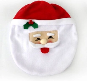 Detail of red and white plush Santa Claus themed toilet cover set on white background