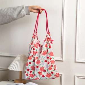 Floral fabric tote bag with red-purple flower patterns and pink rope handles