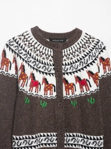 Detail of coffee-colored knit cardigan with jacquard horse and cactus embroidery