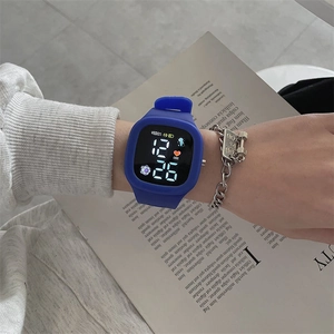 Blue square LED digital watch with silicone strap shown in a lifestyle daily setting
