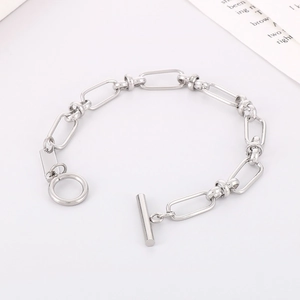 Detail of silver chain bracelet with oval links and T-bar toggle clasp on a white background