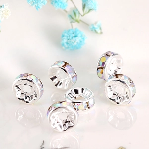 Macro shot of silver spacers with iridescent rhinestones and floral accents