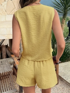 Detail showing the pleated fabric texture and back view of a yellow two-piece summer set