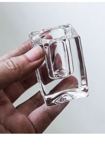 Close-up of a minimalist transparent glass rectangular candle holder with polished finish