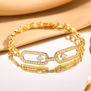 Golden link bracelet with cubic zirconia heart charms and oval motifs on silk