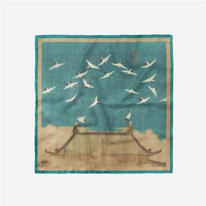 Detailed view of silk square scarf featuring cranes flying over ancient architecture