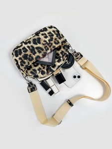 Leopard print crossbody bag with wide strap and double zipper pockets showing capacity