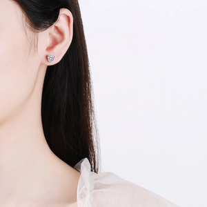 Elegant S925 silver heart-shaped moissanite stud earrings shown on model profile