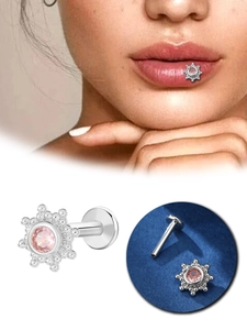 Detail of silver piercing stud with pink zircon flower and model lip placement view