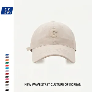 Close-up of the light khaki baseball cap showing 3D embroidered C letter and cotton fabric