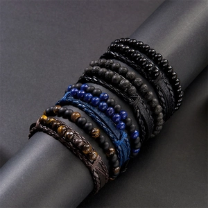 Detail of layered leather wrap bracelet with tiger eye beads and braided cords on a display