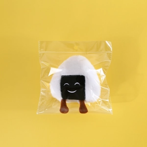 Macro shot of onigiri plush toy with embroidered face and catnip inside