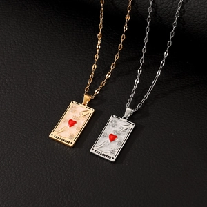 Macro shot of gold and silver tarot lovers pendants on a textured black leather background