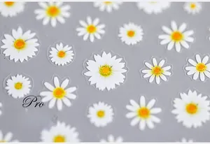 Detailed view of 5D white daisy nail art stickers with embossed petals and yellow centers