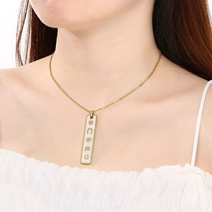 Detail of 18K gold plated rectangular pendant with lucky 13 and clover engravings