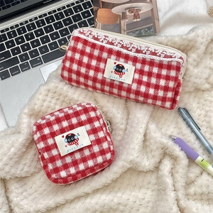 Detail of red and white checkered knit pouch and pencil case with black cat embroidery