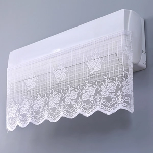 Close-up of white lace air conditioner cover with floral embroidery and scalloped edges
