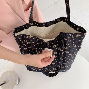 Detail view showing interior pocket and quilted floral canvas texture of the tote bag