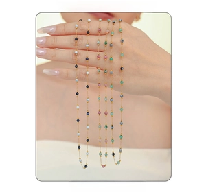 Close-up of handmade gold-plated beaded necklaces with natural blue and green stones