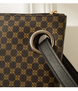 Detail of crocodile pattern briefcase with metal eyelets and premium leather textures