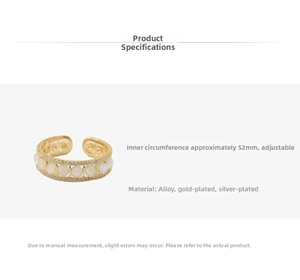 Detail of gold-plated cross ring featuring cat eye stones and sparkling zircon accents