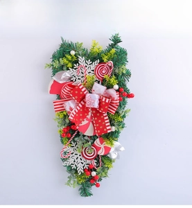 Detail of a Christmas teardrop swag with candy canes and red polka dot bows