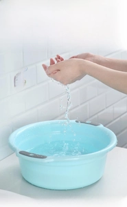Detail of light blue heat-resistant PP plastic basin showing durability in water