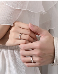 Detailed close-up of S925 silver couple rings showing woman's diamond ring and man's band