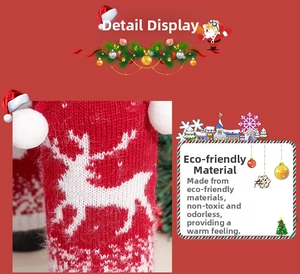 Close-up of knitted Christmas wine bottle cover with white reindeer pattern and pompom