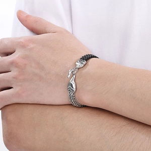 Detailed view of bicolor fish scale men's bracelet with silver buckle on wrist