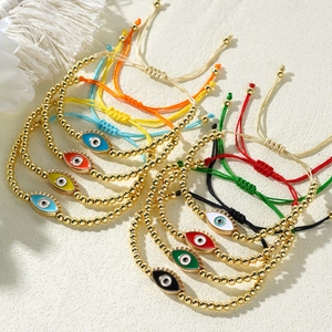 Detail of 4mm copper bead Evil Eye bracelets with colorful enamel charms and adjustable cords